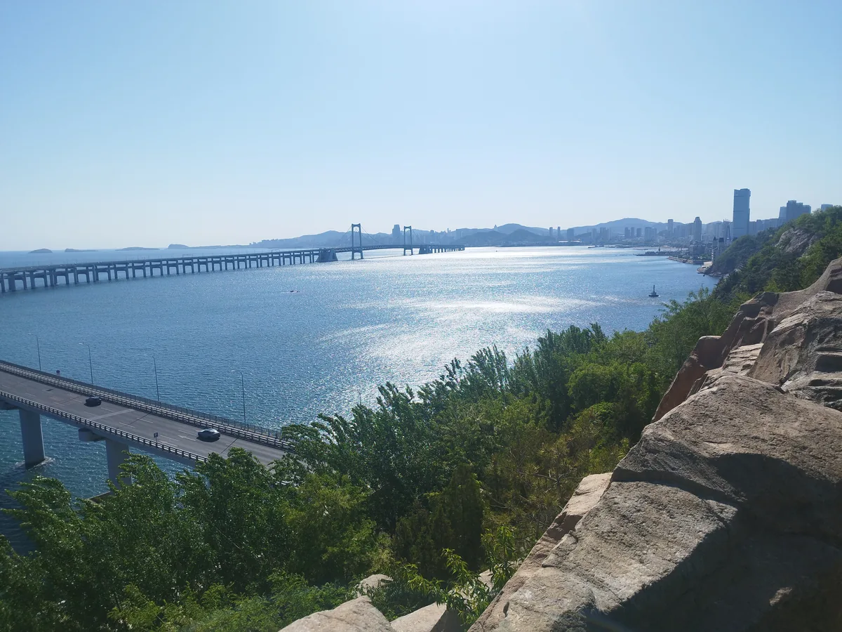 Red walking path of the Binhai Road route with sea creatures on the cliff